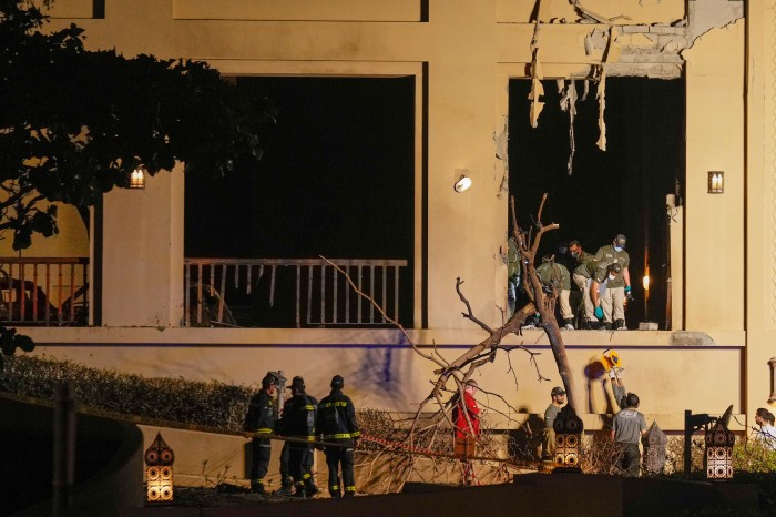 Firemen and rescue workers inspect the site of an explosion at the Fairmont The Palm Hotel in Dubai.